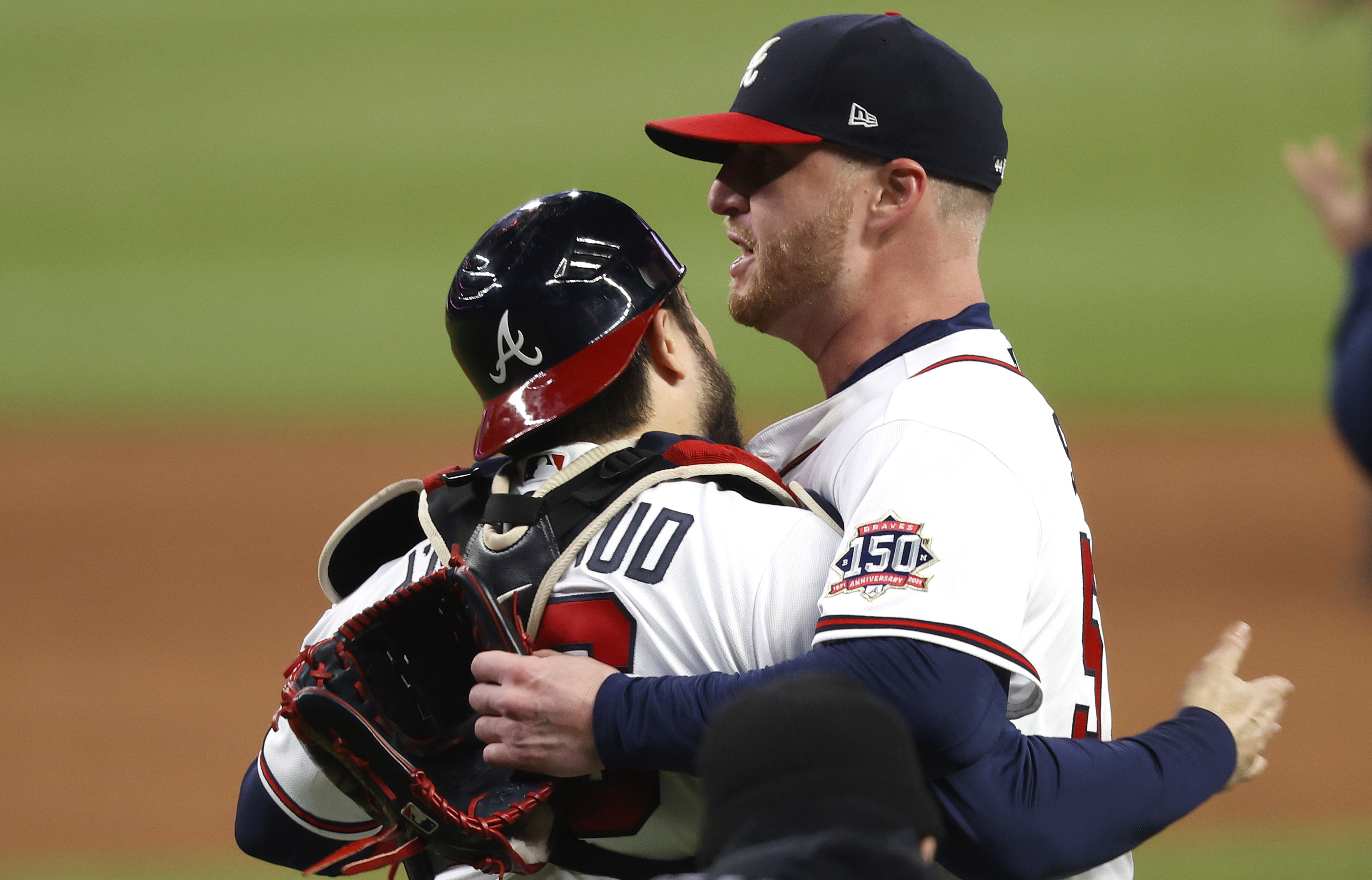 Travis d'Arnaud hugs closer Will Smith after the Braves' 3-2 win over the Astros in Game 4.