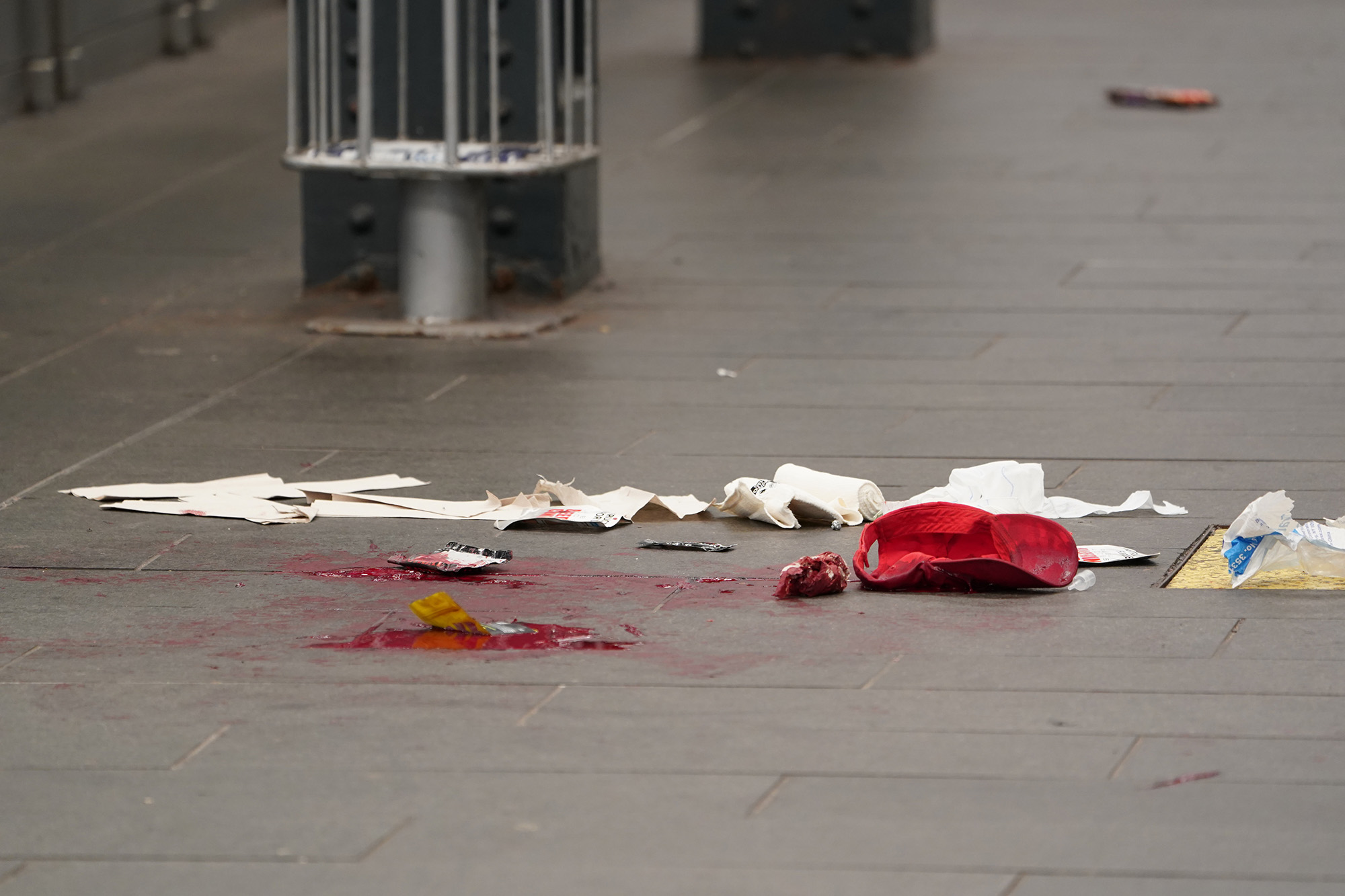 A baseball cap seen amid the blood at the scene of the stabbing.