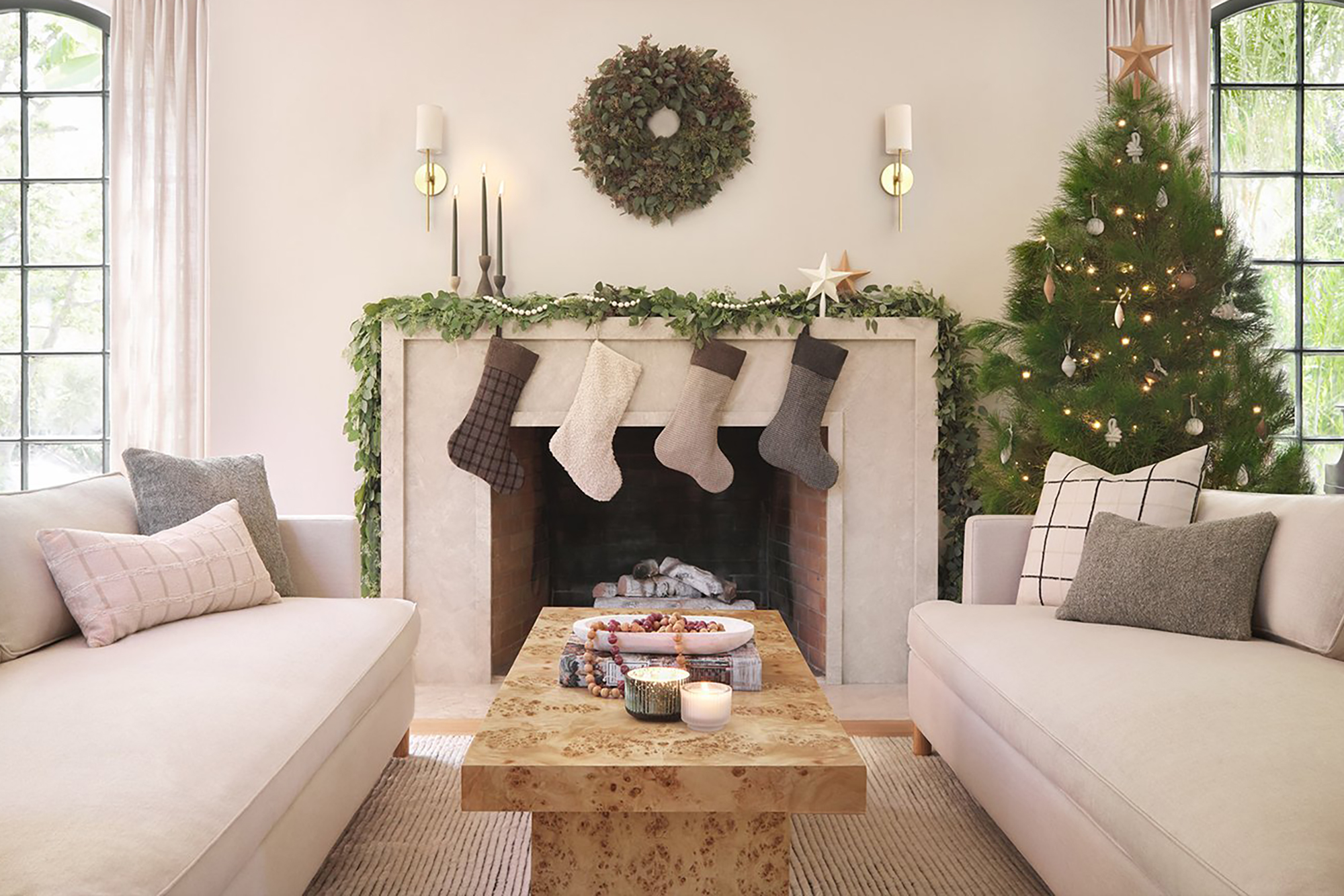 A white living room with a tree and white stockings 