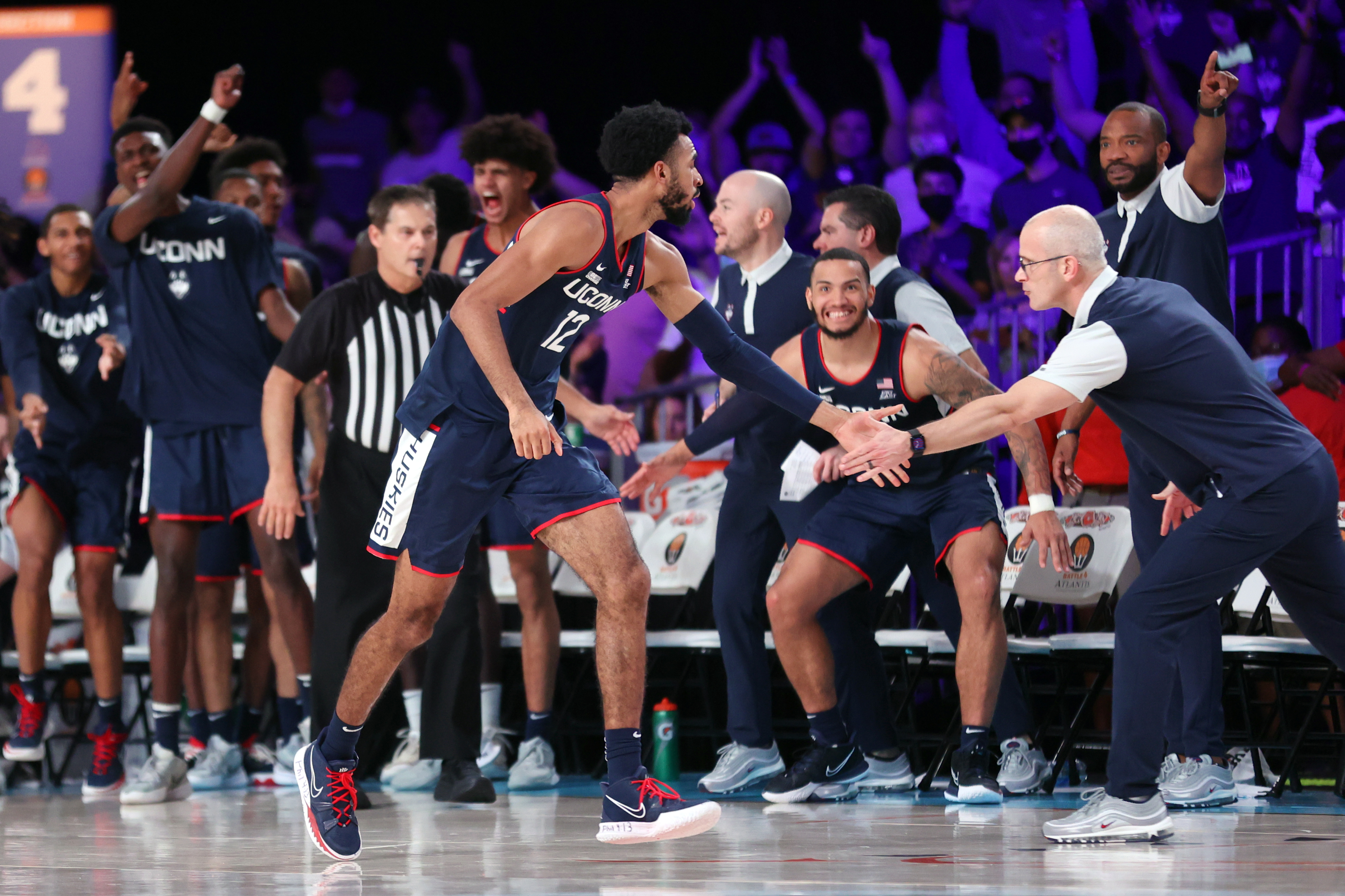 UConn forward Tyler Polley is congratulated by coach Dan Hurley after making a 3-pointer against Auburn in the second overtime of an NCAA college basketball game at Paradise Island, Bahamas, Wednesday, Nov. 24, 2021.