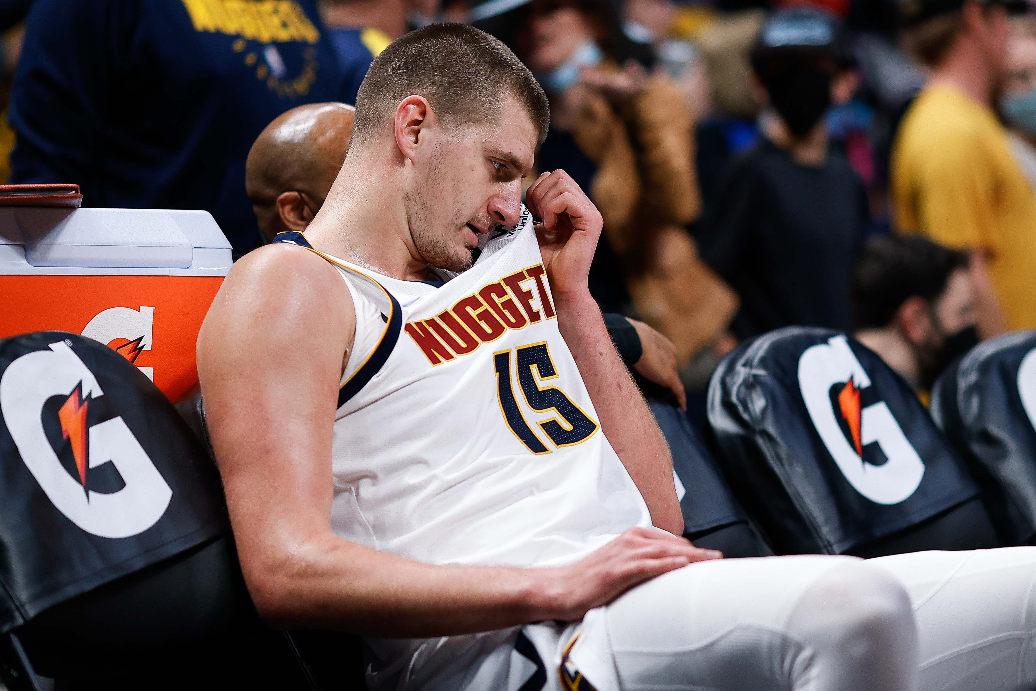 Nikola Jokic sits on the Nuggets bench during their game against the Heat.