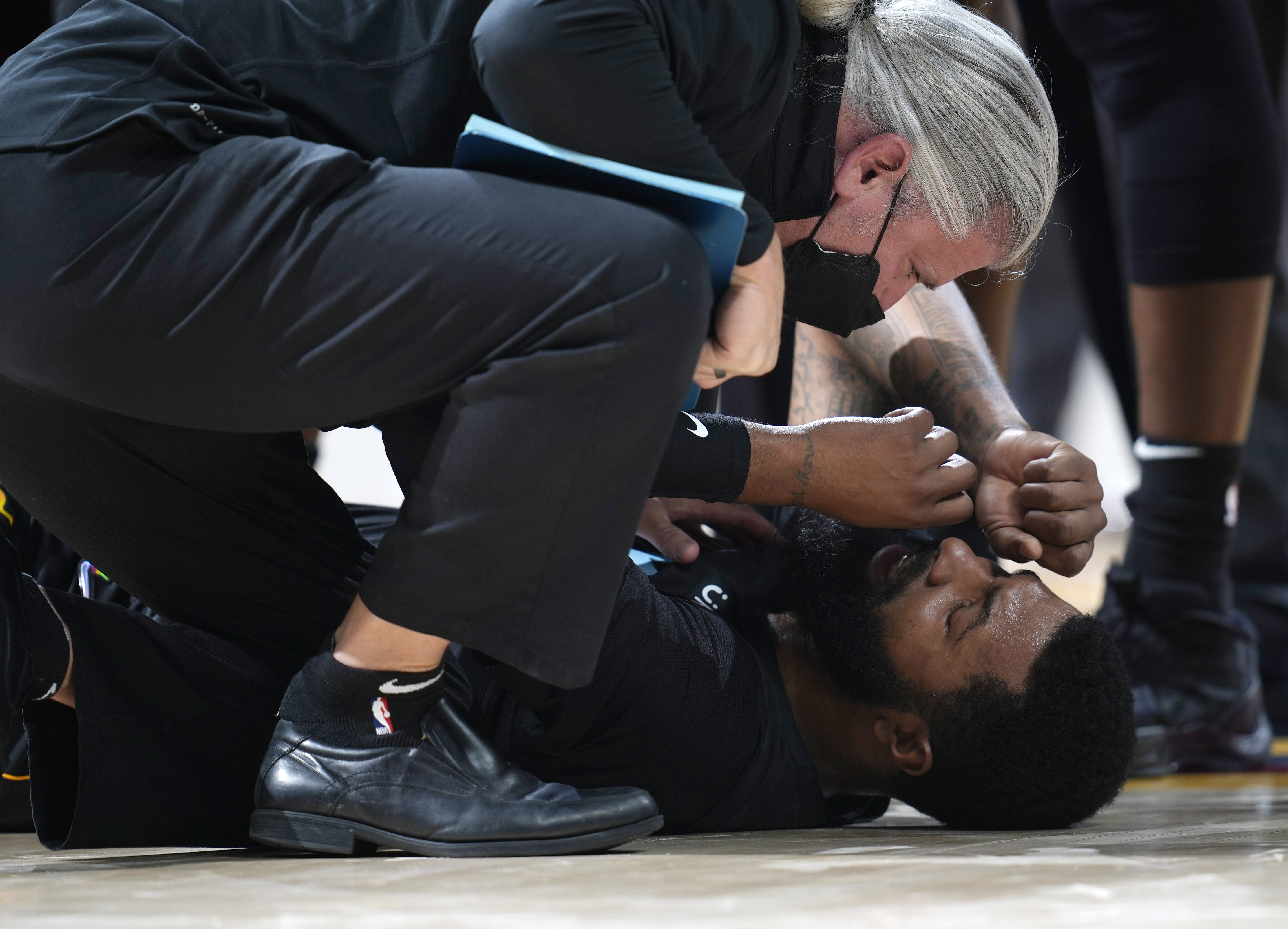 Markieff Morris lays on the floor after getting shoved by Nikola Jokic.