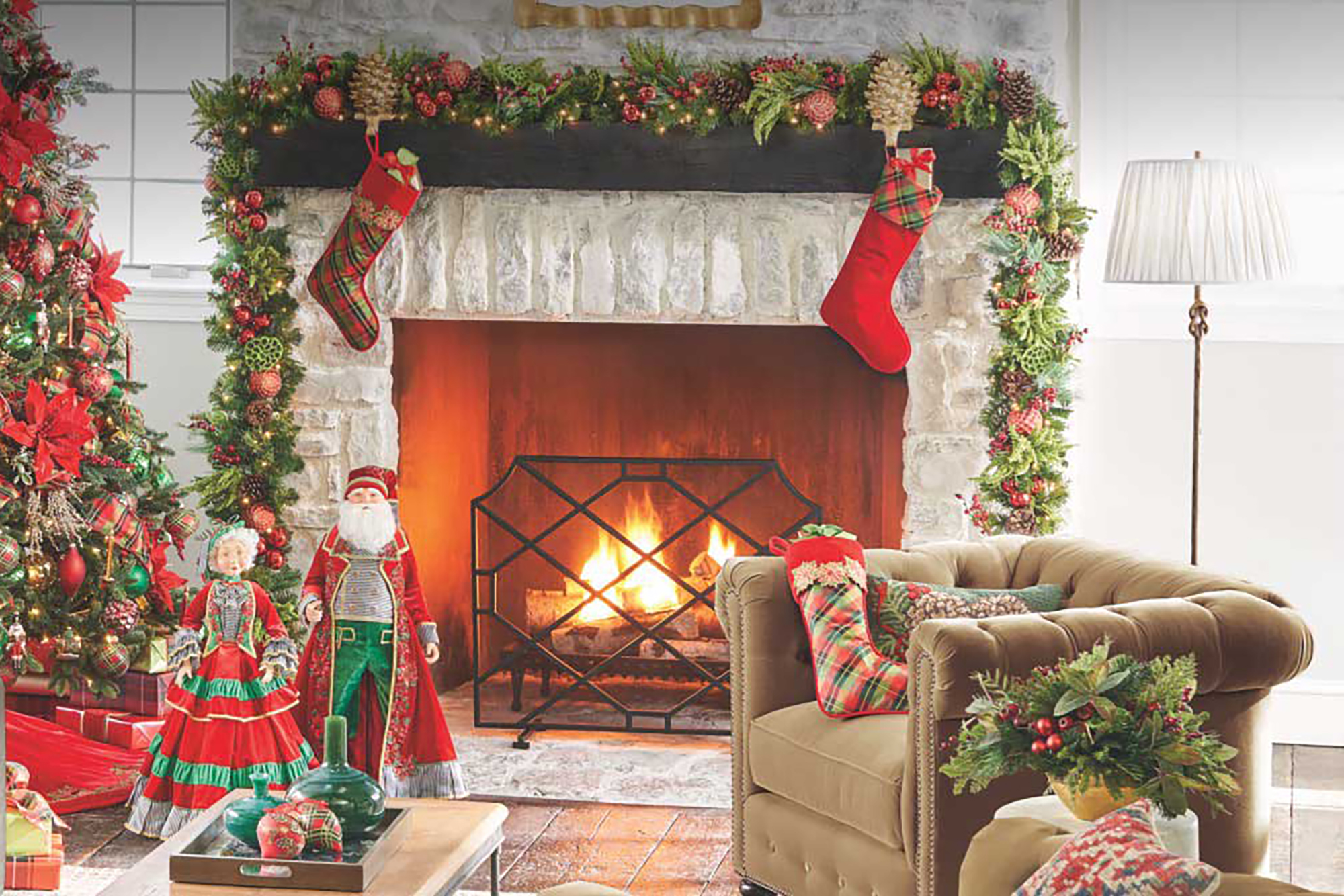 A home decorated for Christmas and a fireplace burning 