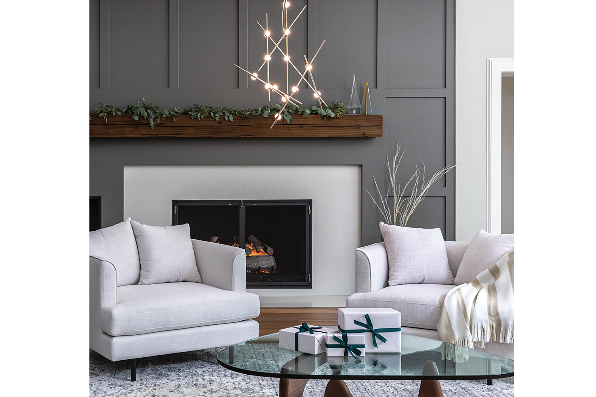 A living room with a white chair and fireplace