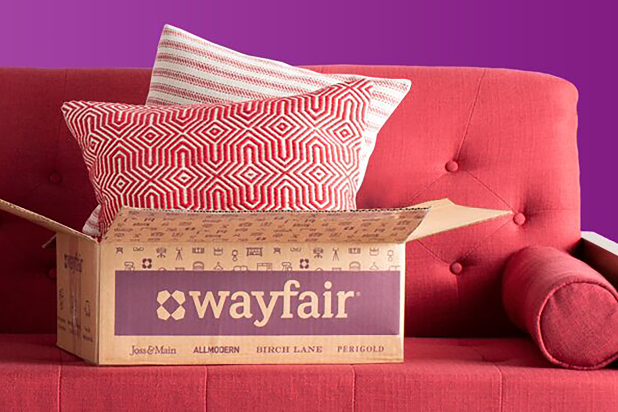 A Wayfair box on a red couch 