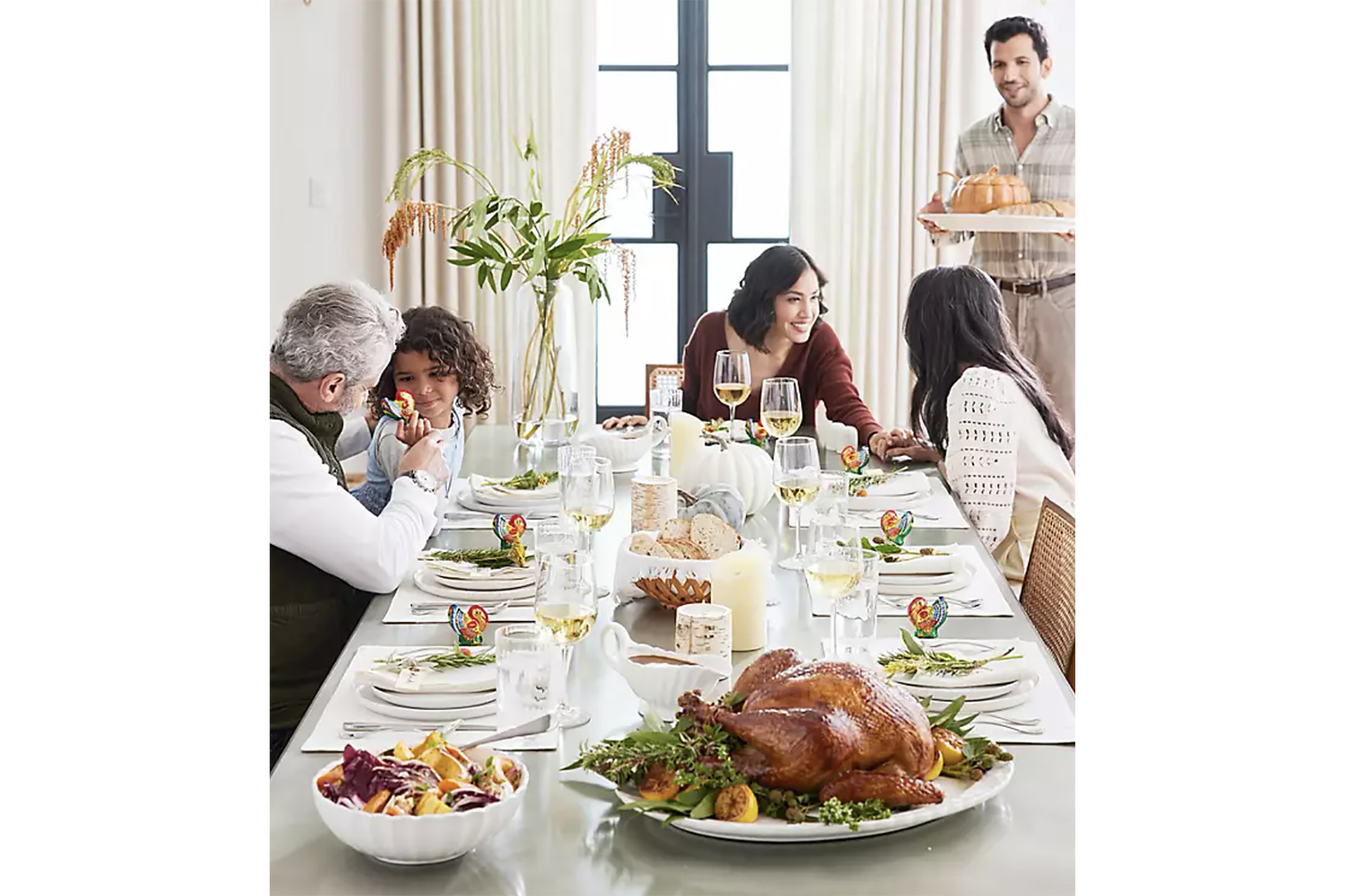 A family at a set Thanksgiving table 