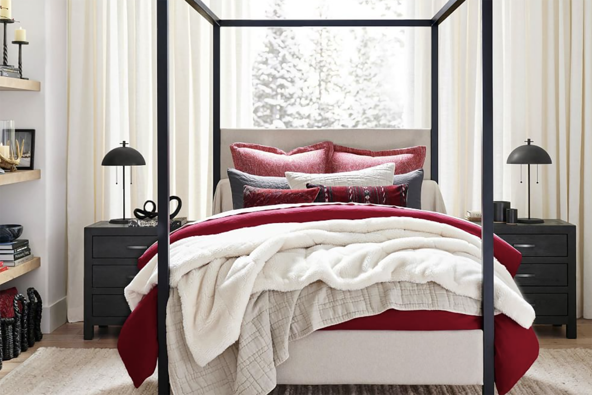 A red and white bedding set on a four poster bed 