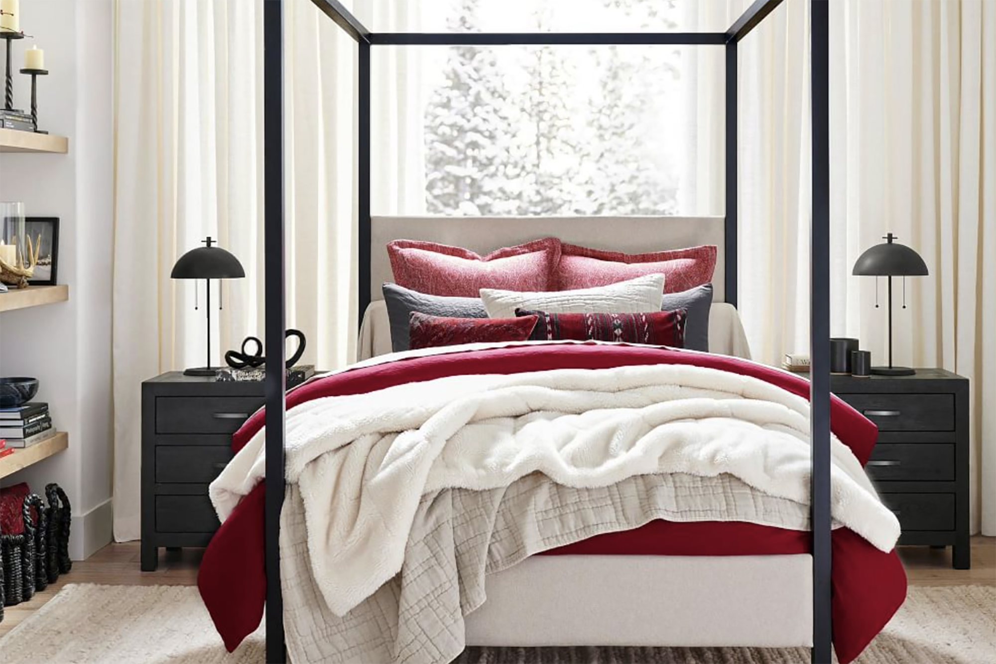 A red and white bedding set on a four poster bed