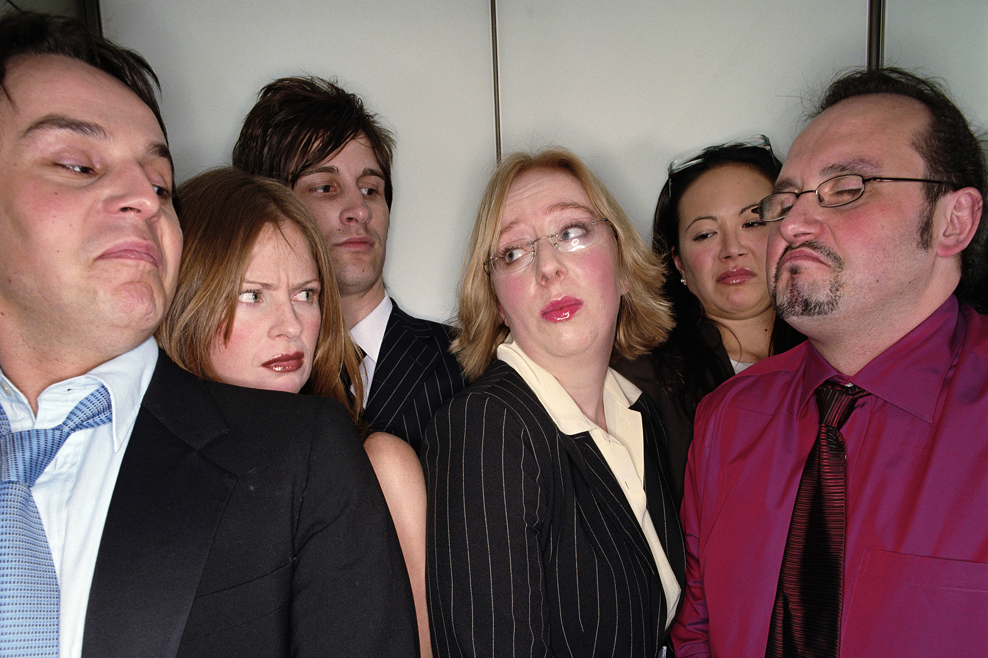 Group of business people in lift, close-up