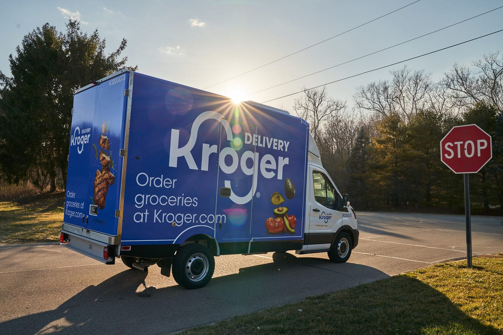 A Kroger delivery truck on the road.