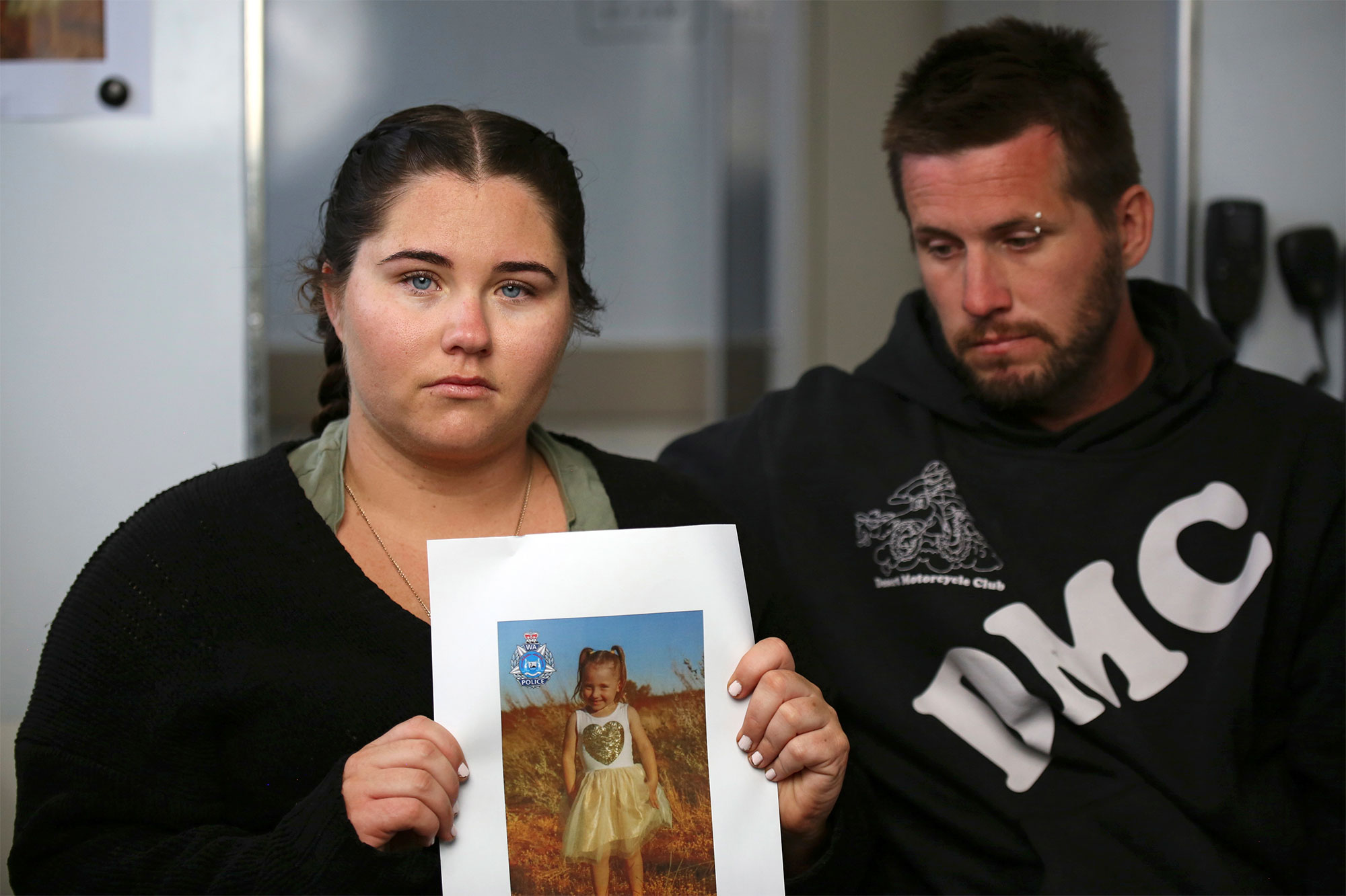 Ellie Smith, left, and her partner Jake Gliddon, display a photo of their missing daughter.
