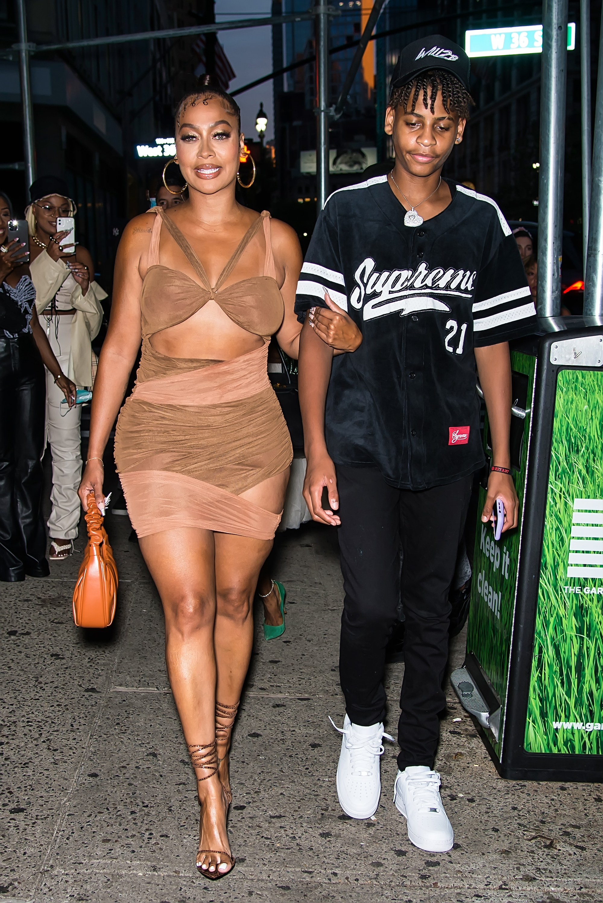 La La Anthony links arms with her son, Kiyan.