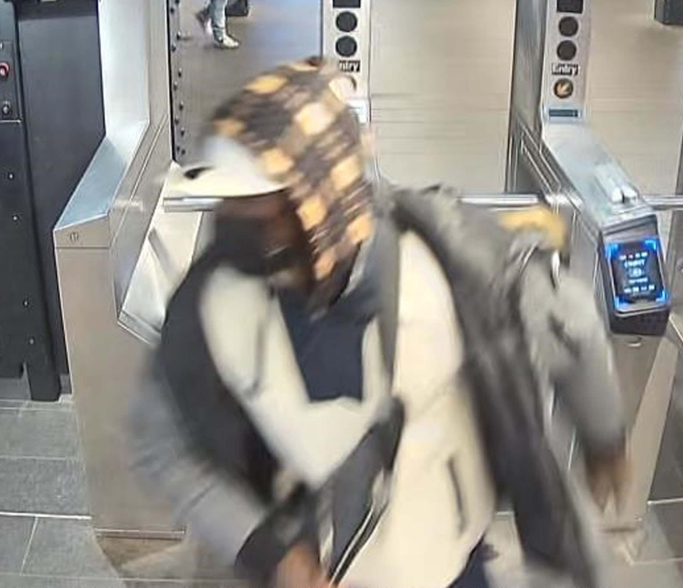 turnstile footage shows the suspect who was covered from head to toe in clothing making it impossible to discern any features. 