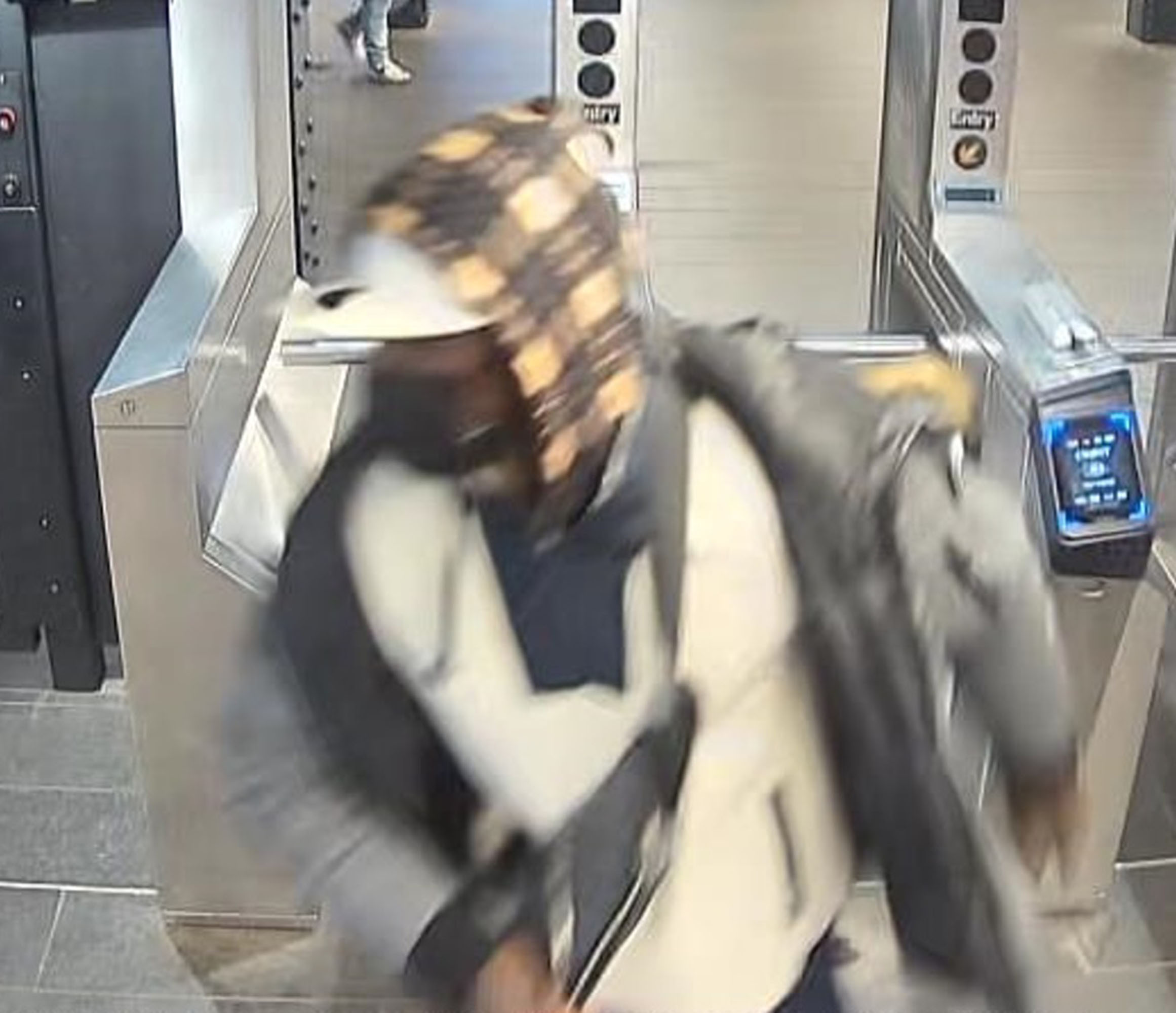 turnstile footage shows the suspect who was covered from head to toe in clothing making it impossible to discern any features.