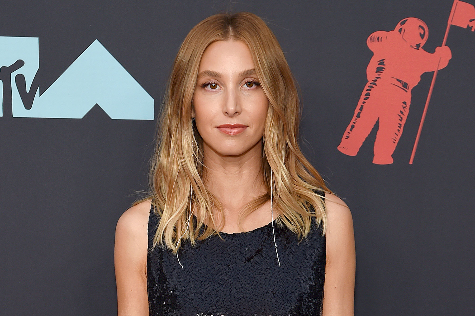 Whitney Port posing on the red carpet while wearing all black