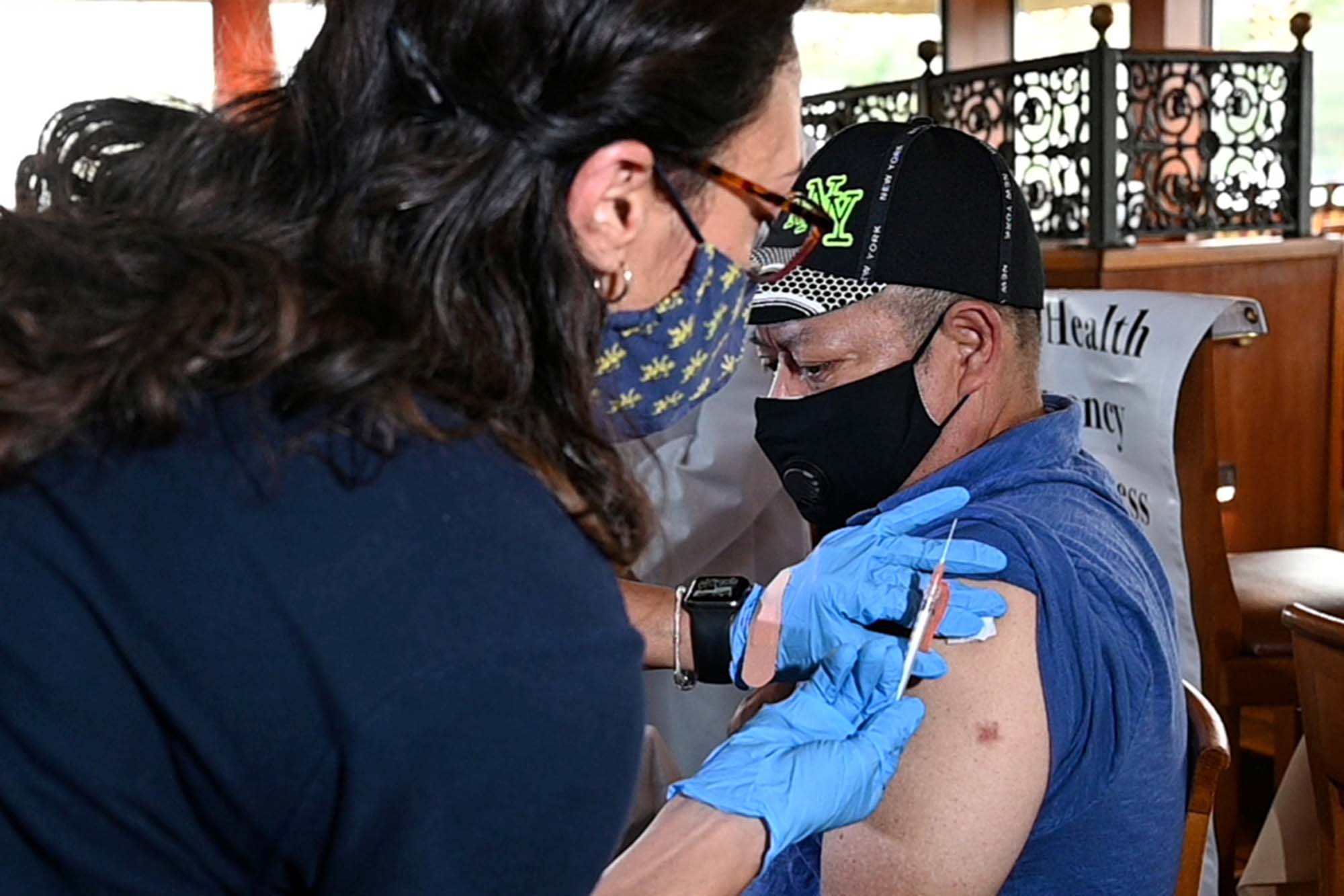 Angel Human, an employee at Cafe Baci in Westbury, New York, gets his Covid-19 vaccination.