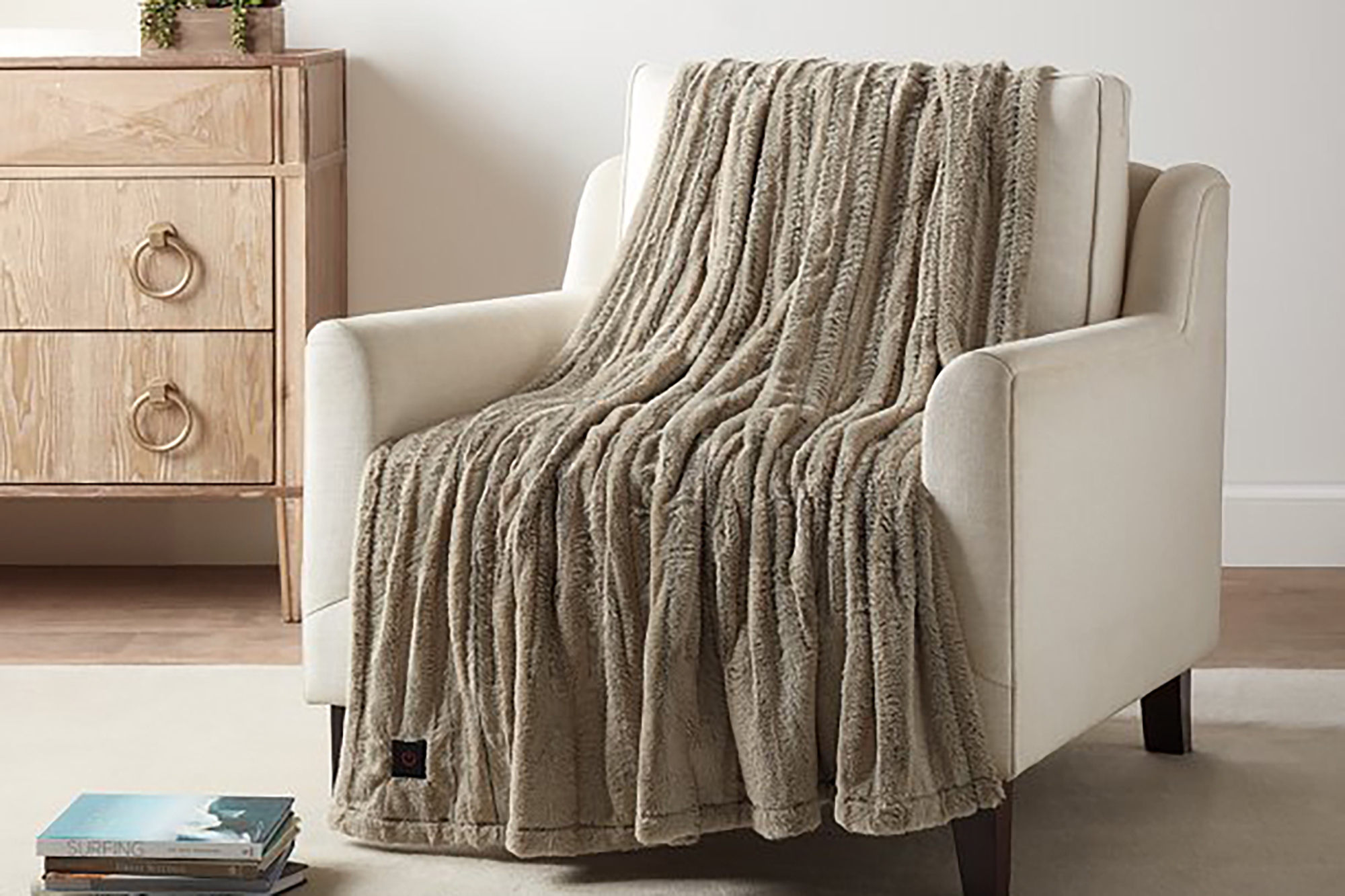 A taupe throw blanket on a chair 