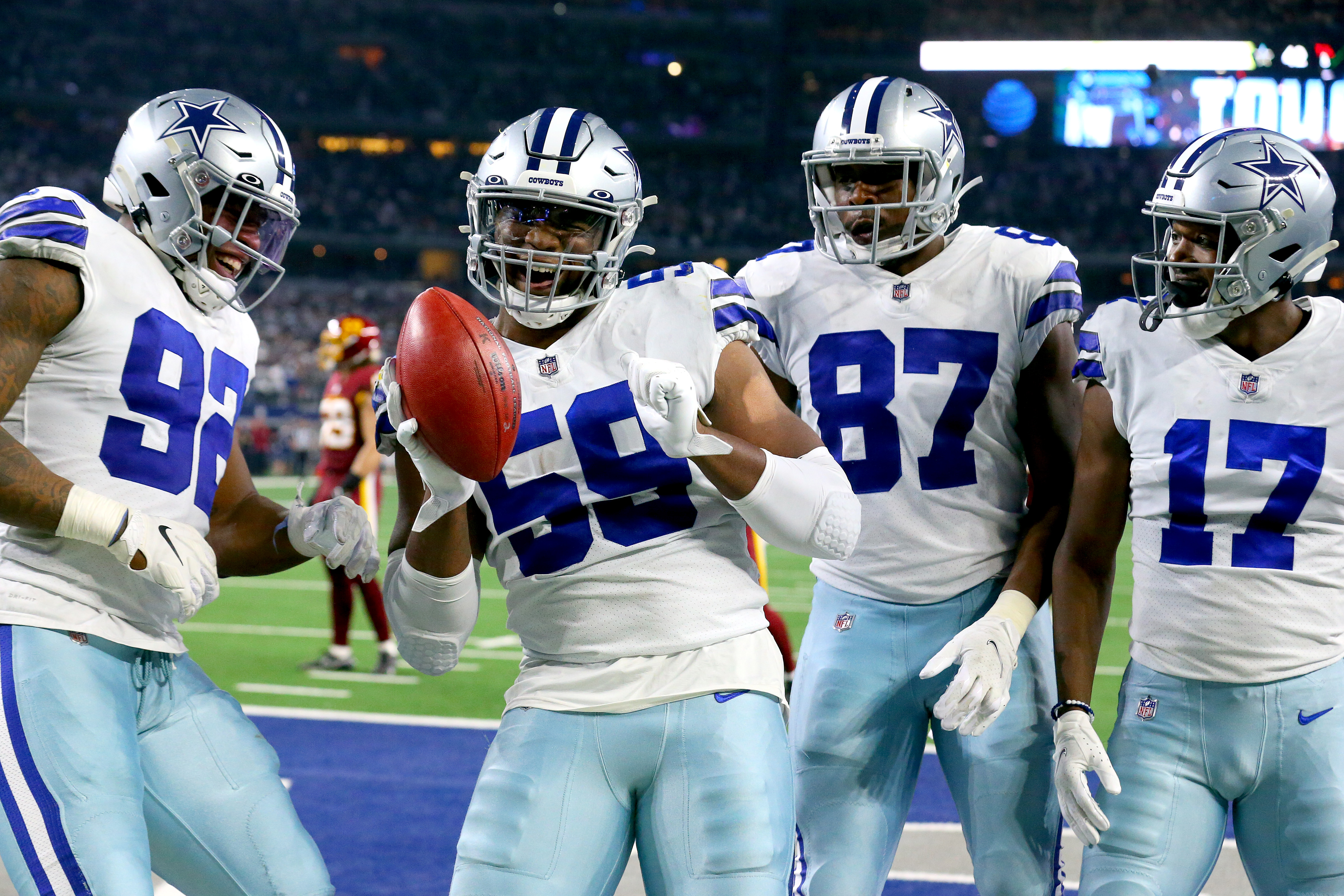 Chauncey Golston (59) celebrates after recovering a blocked punt for a touchdown.