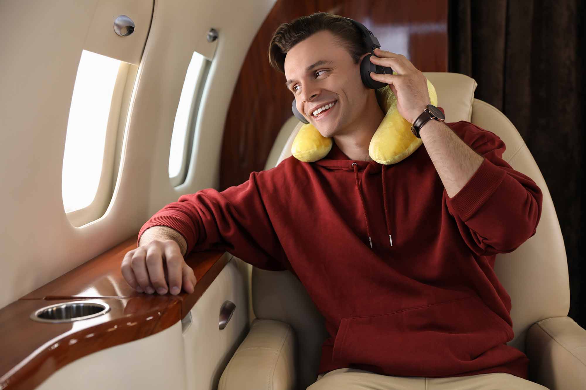 pillow and headphones listening to music in airplane during flight.