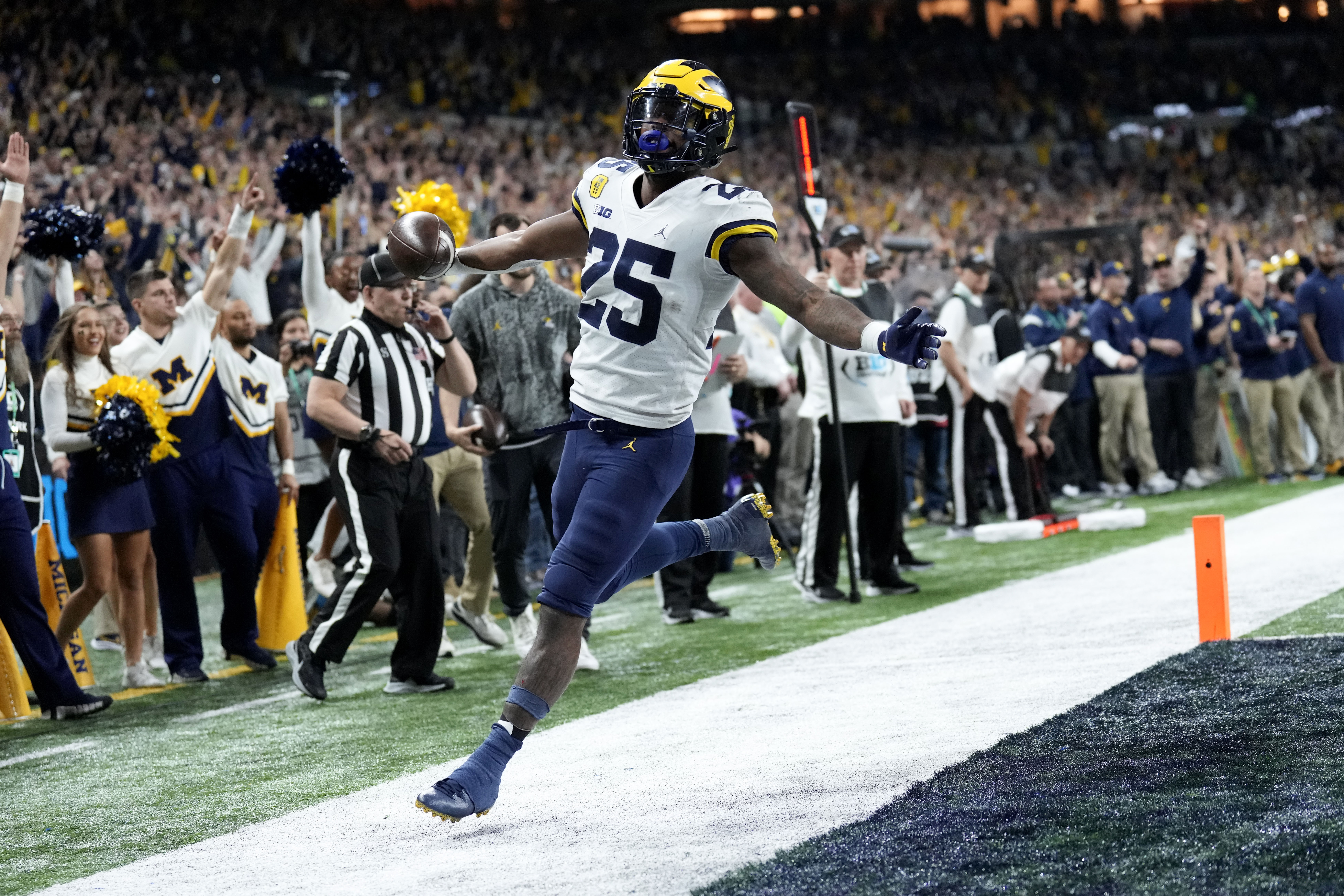 Hassan Haskins celebrates after scoring on one of his two rushing touchdowns in Michigan's Big Ten title win.