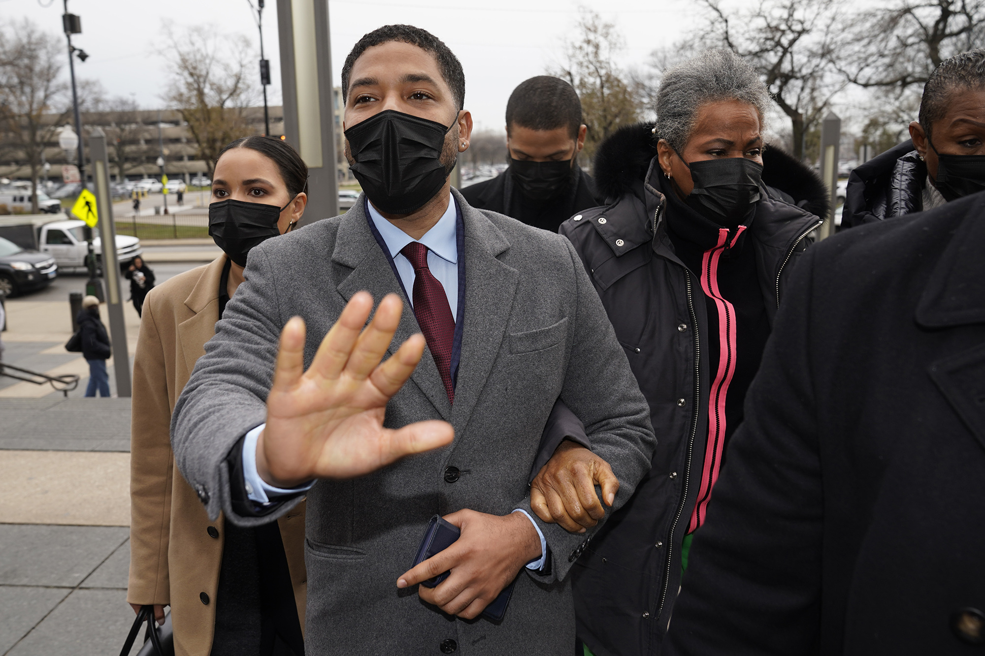 Actor Jussie Smollett asks photographers to move back as he arrives with his mother Janet, right, at the Leighton Criminal Courthouse for day three of his trial in Chicago on Wednesday, Dec. 1, 2021.
