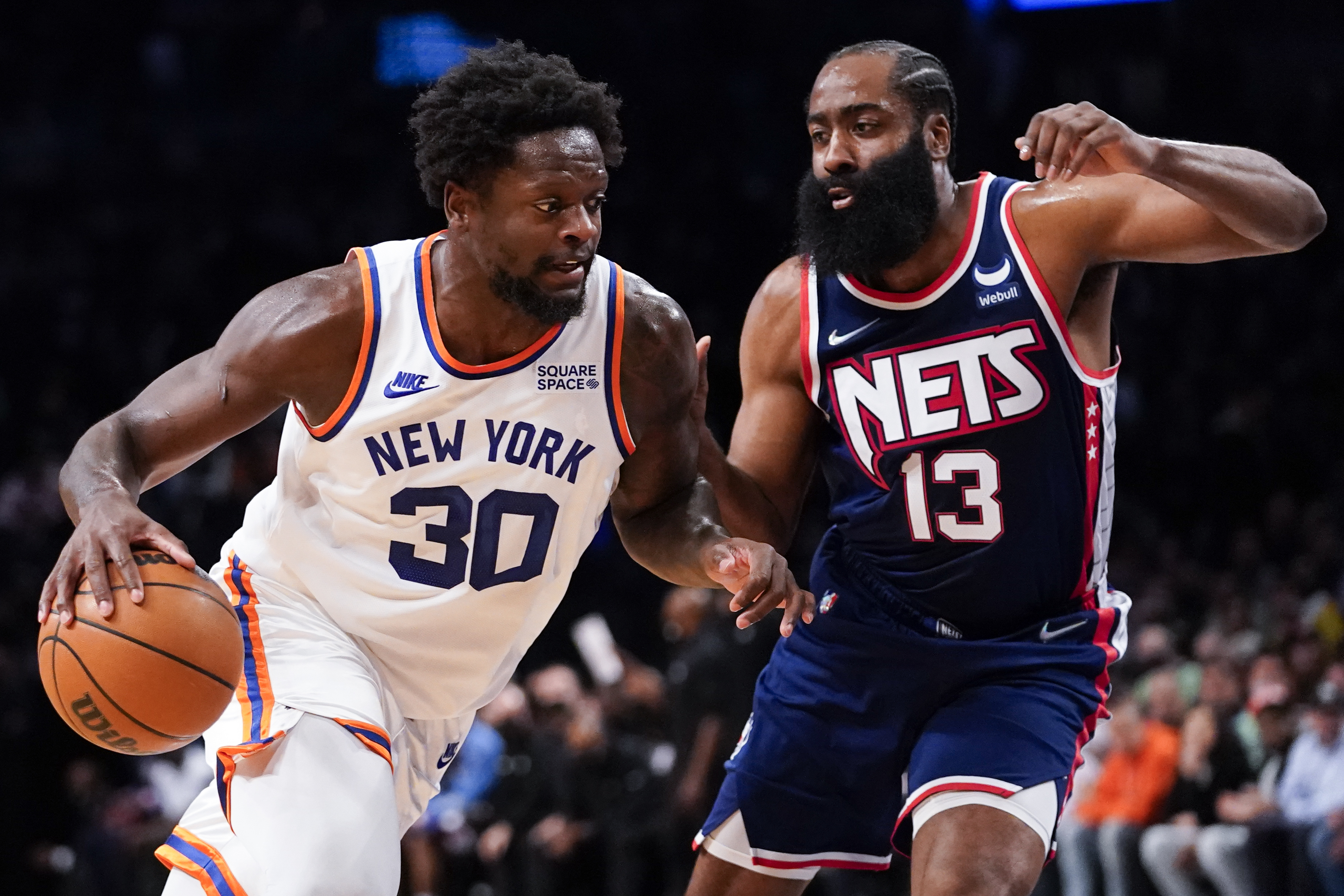 Knicks forward Julius Randle drives against Brooklyn Nets guard James Harden (13) during the first half of a game, Tuesday, Nov. 30, 2021.