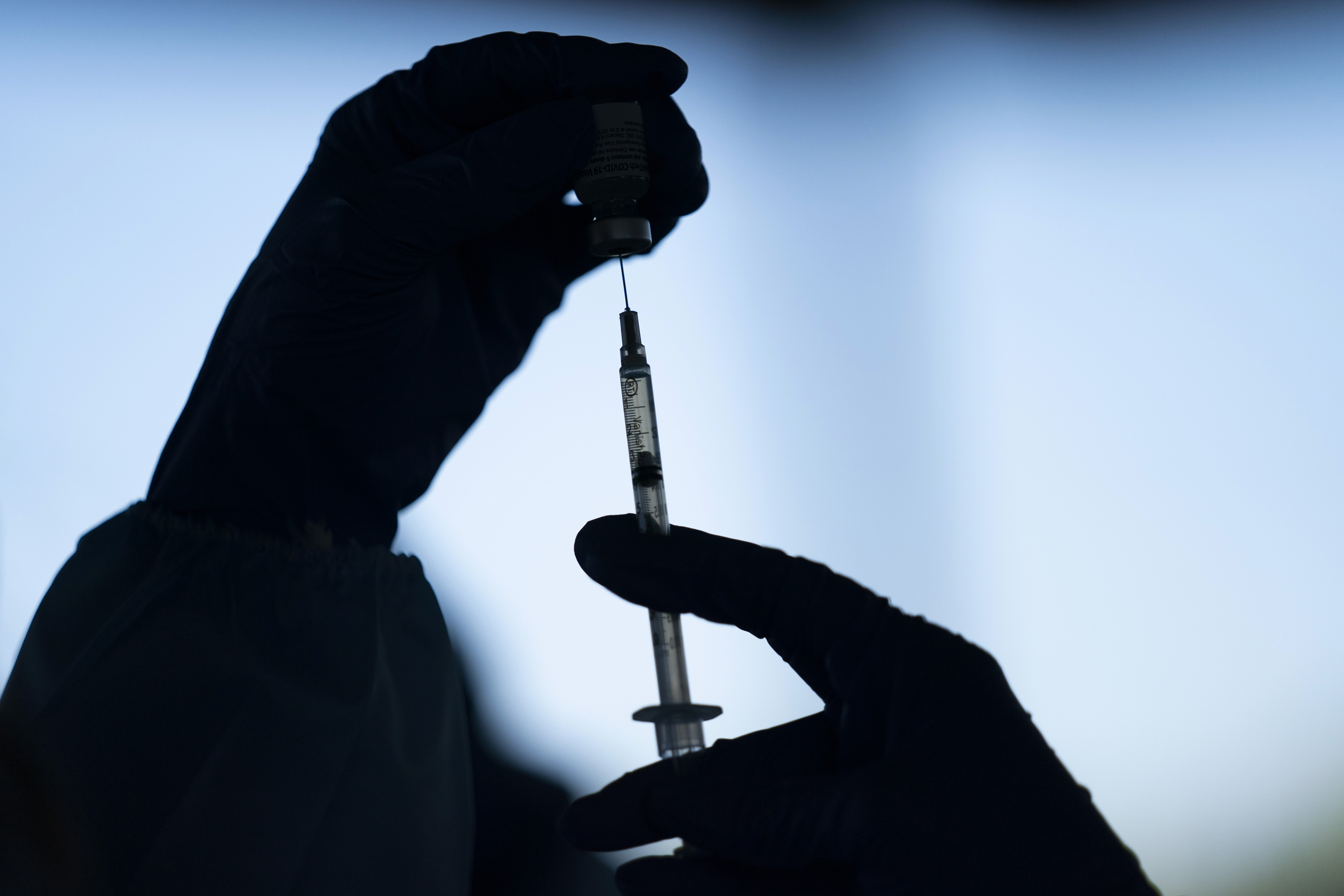 A medical staff member prepares the Pfizer-BioNTech COVID-19 vaccine at Tudor Ranch in Mecca, Calif.