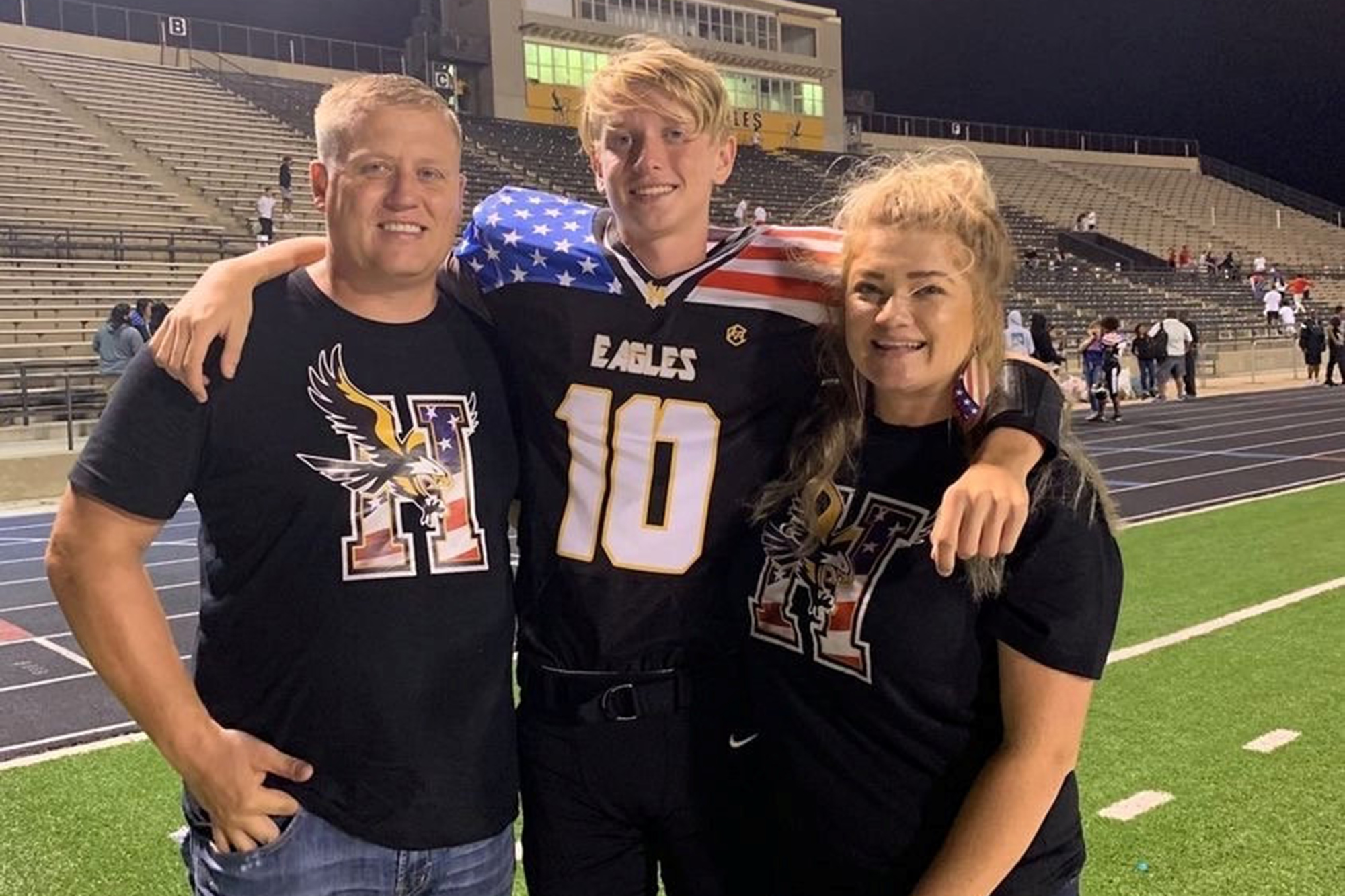 Kooper (center) with his mom Heather and dad Justin after one of Kooper's football games.