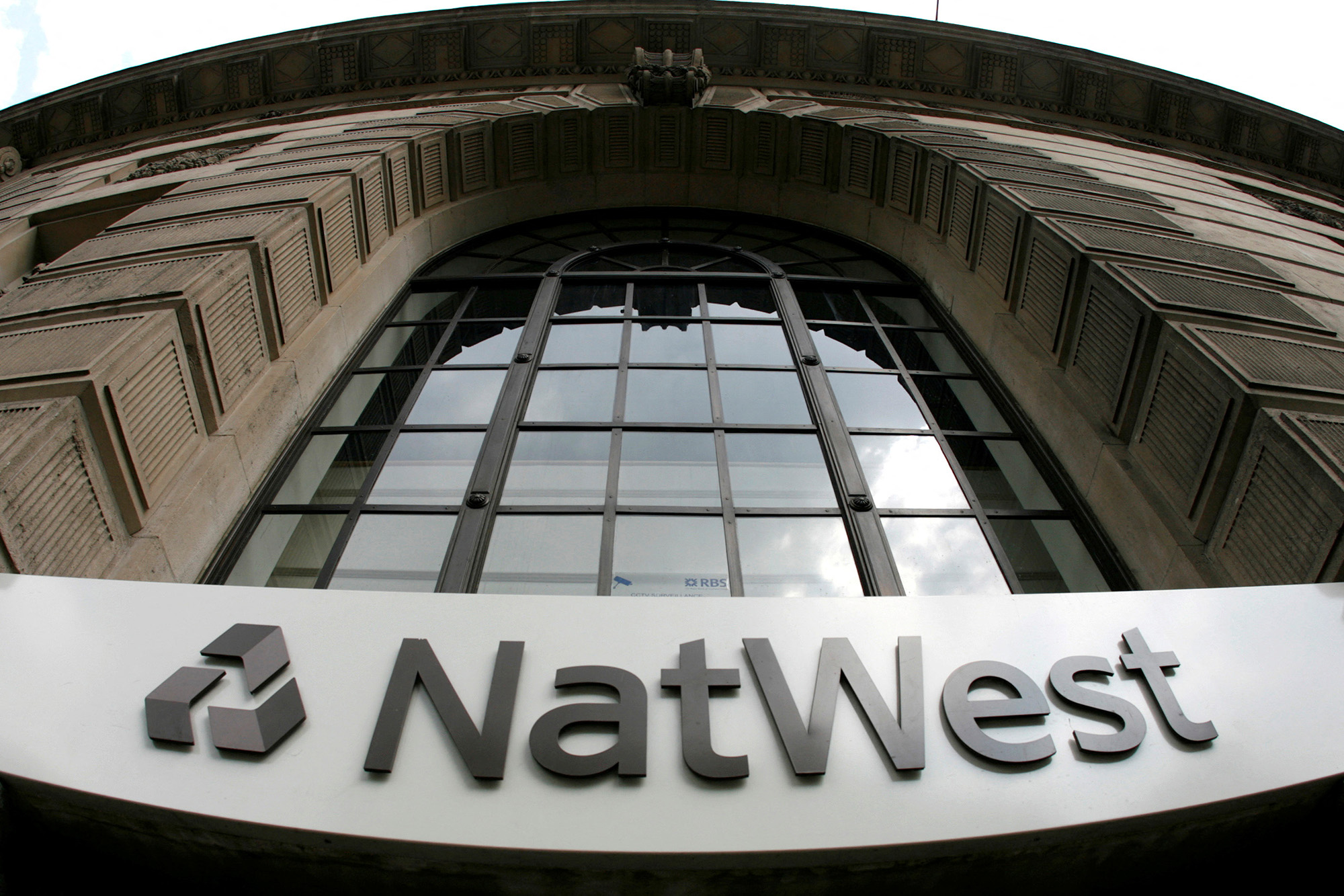 A NatWest sign at brick office building