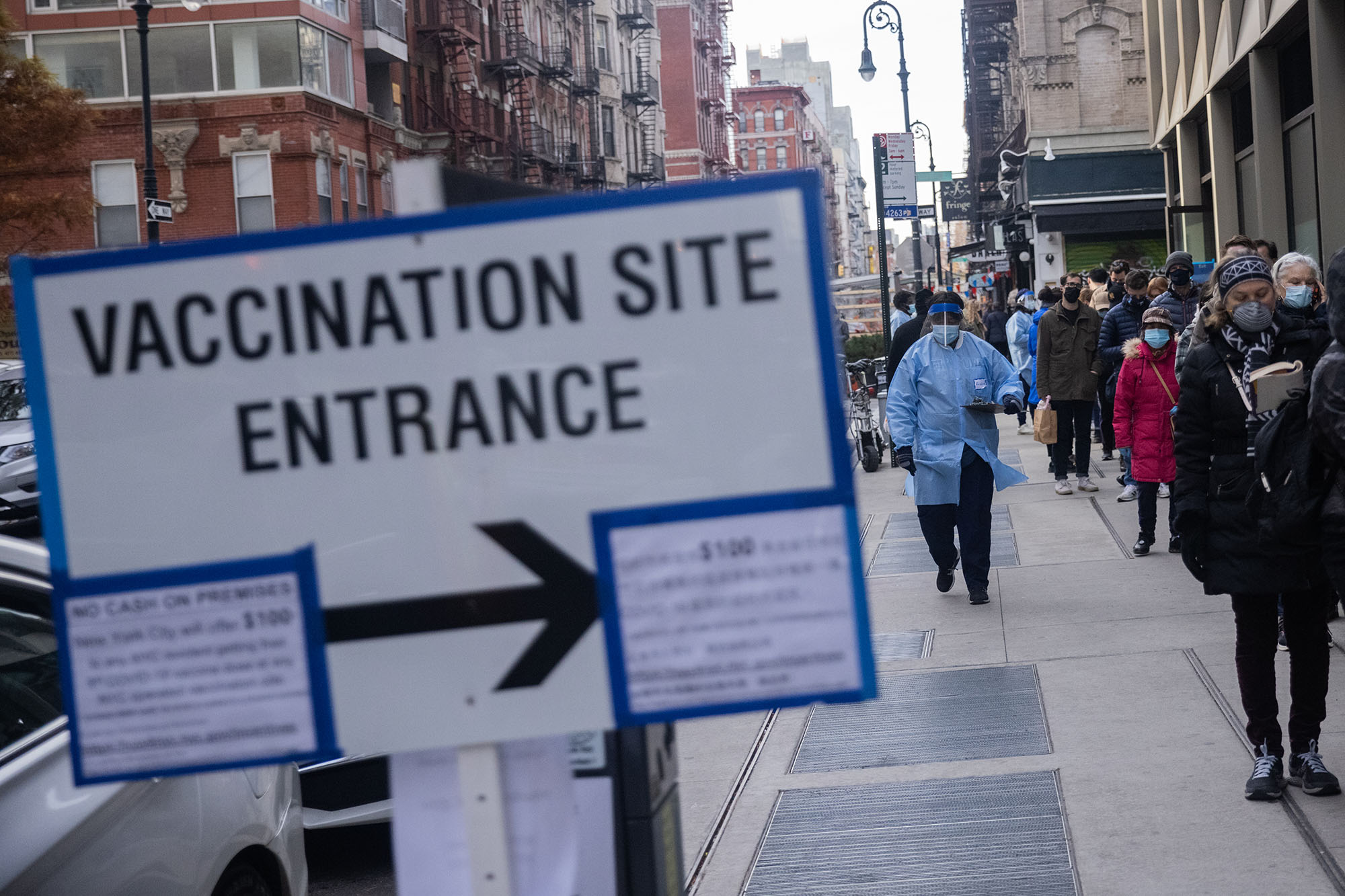 Residents wait in line at a COVID-19 vaccination site.