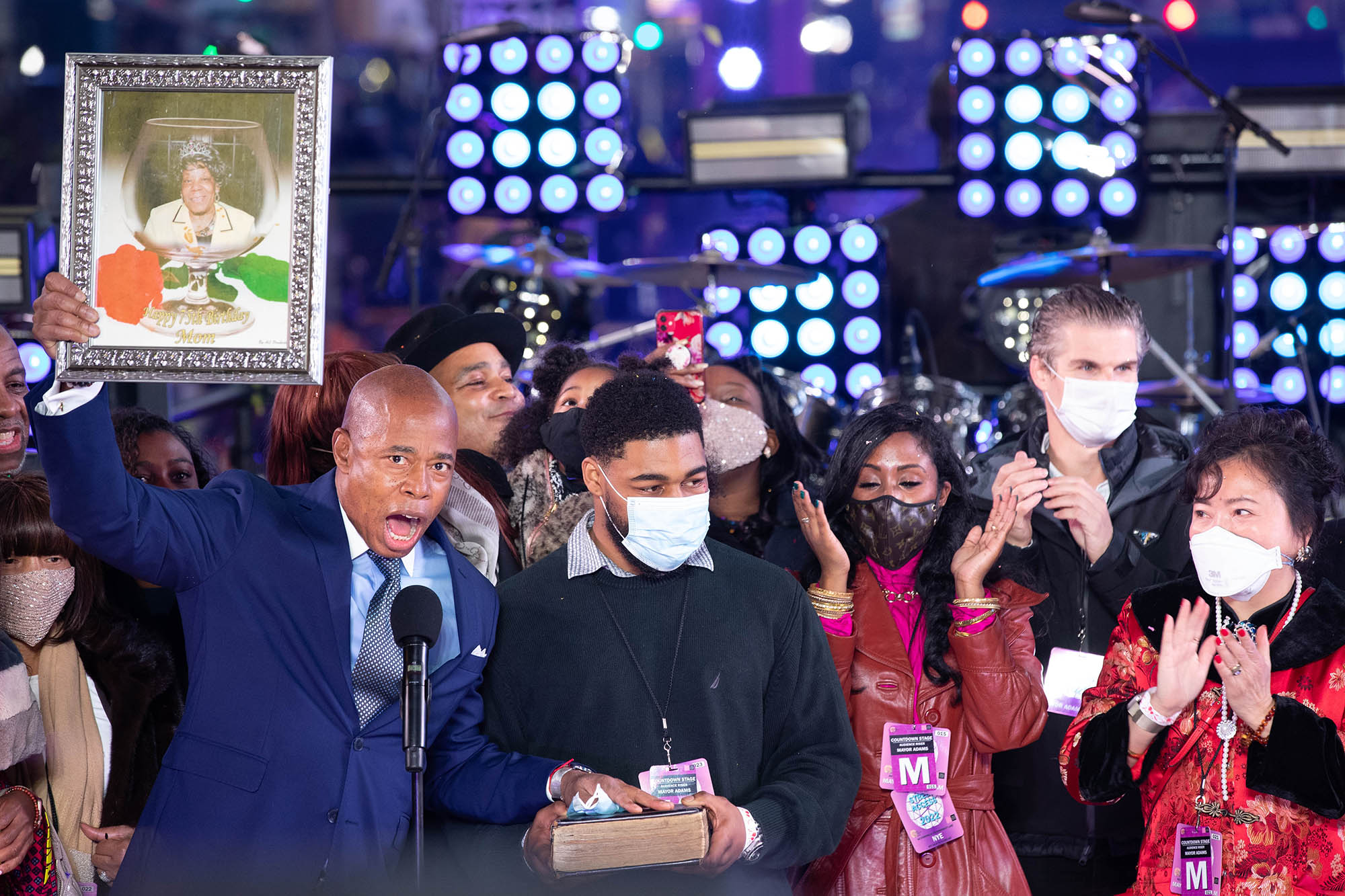 Mayor Eric Adams raises a photo of his late mother during the ceremony on Jan. 1, 2022.