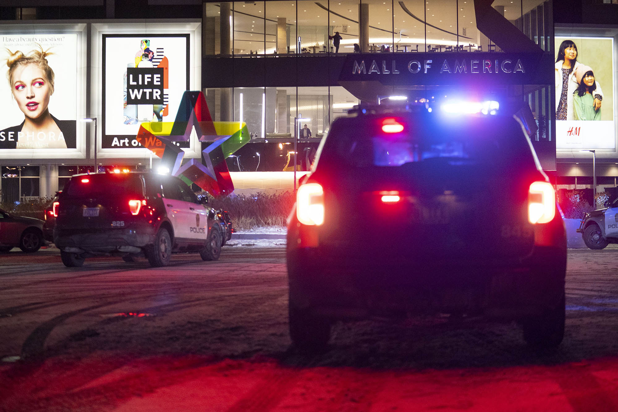 Bloomington Police vehicles are parked outside of the Mall of America following a shooting in Bloomington, Minn. on Dec. 31, 2021.