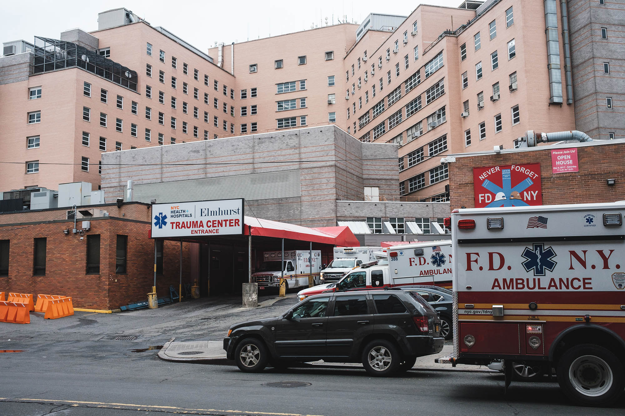 People wait for a free covid test at Elmhurst Hospital in Queens during the outbreak of the Omicron variant of Covid-19.